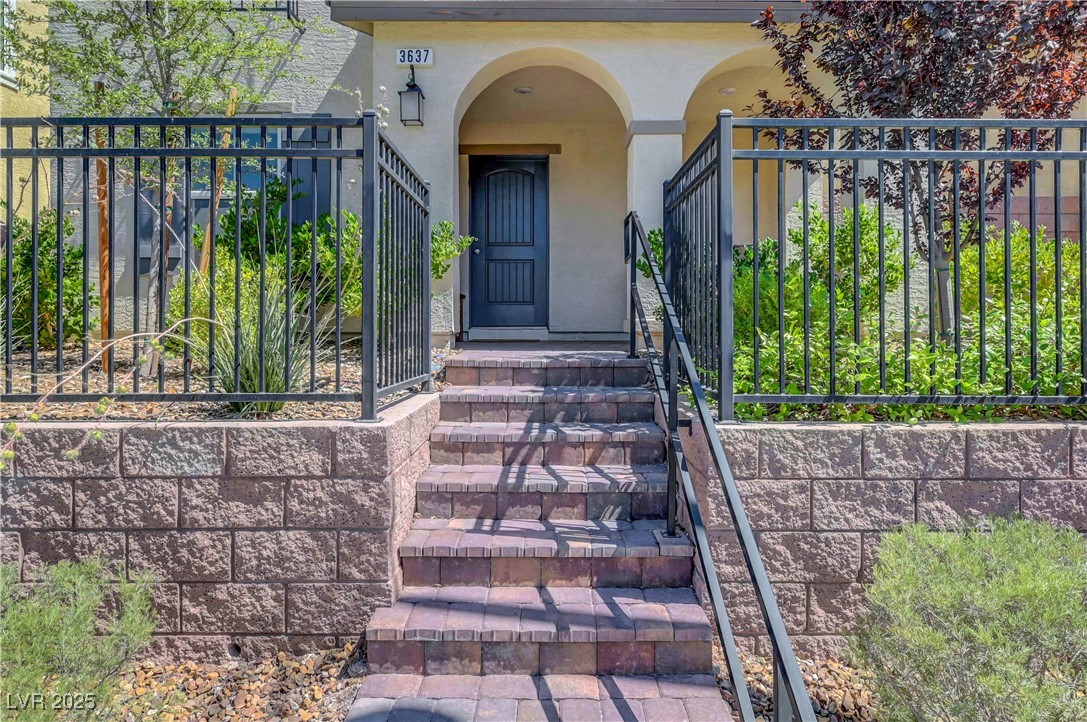 3637 Modico Lane Henderson, NV 89044 - Photo 5 of 62 View of exterior entry with stucco siding and a ga