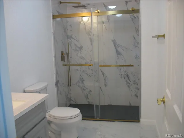 a bathroom with a toilet and a shower