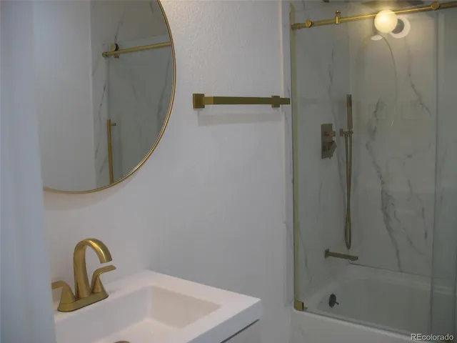 a bathroom with a sink and mirror