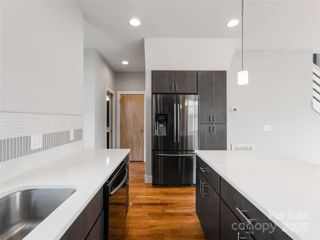 a kitchen with a stove a sink and a window