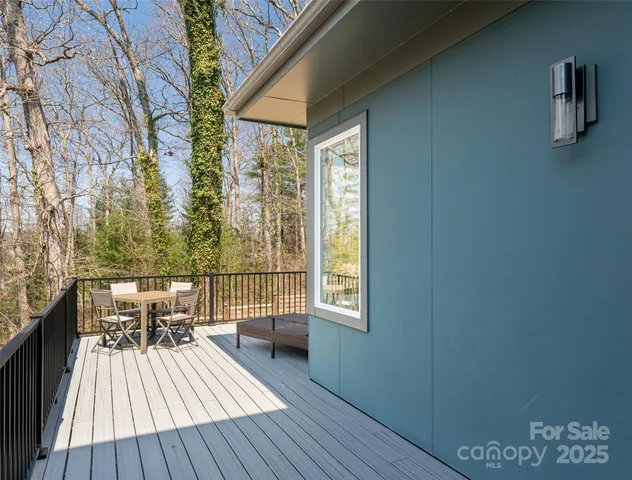 a view of a roof deck with table and chairs and wooden floor