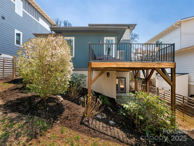 a balcony with next to a yard