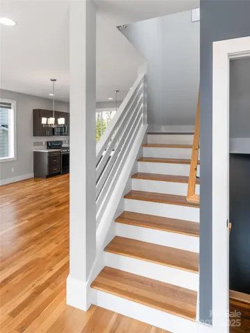 a view of entryway and hall with wooden floor