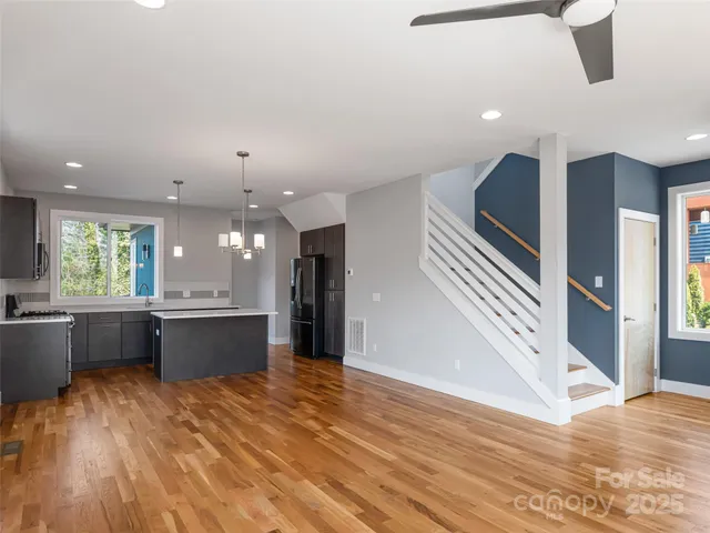 a large kitchen with lots of counter space and stainless steel appliances