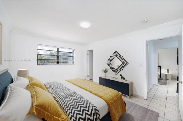 a bedroom with a bed and a mirror