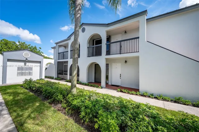 a front view of a house with yard and garage