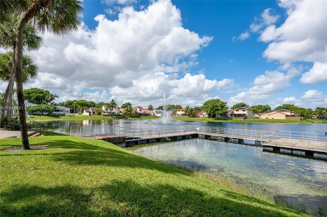 a view of a lake with houses in the back