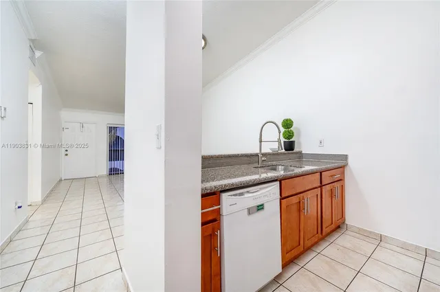 a kitchen with granite countertop a sink and a stove