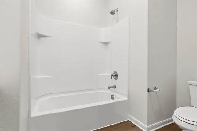 a bathroom with a bathtub and a toilet