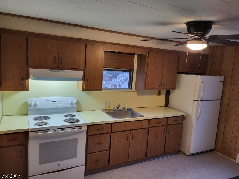 56 Maple Avenue, Unit 2 Rockaway, NJ 07866 - Photo 7 of 8 a kitchen with a sink a refrigerator and cabinets