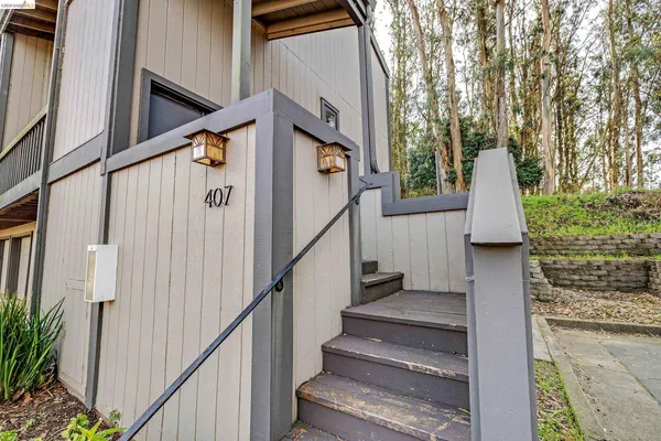 a view of entryway with wooden floor and stairs