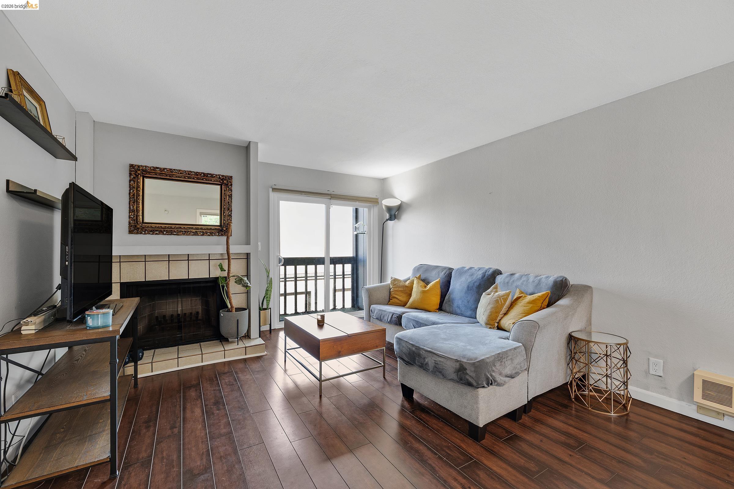 407 Vista Heights Road El Cerrito, CA 94530 - Photo 11 of 29 Living area with a tile fireplace and hardwood / wood-style flooring
