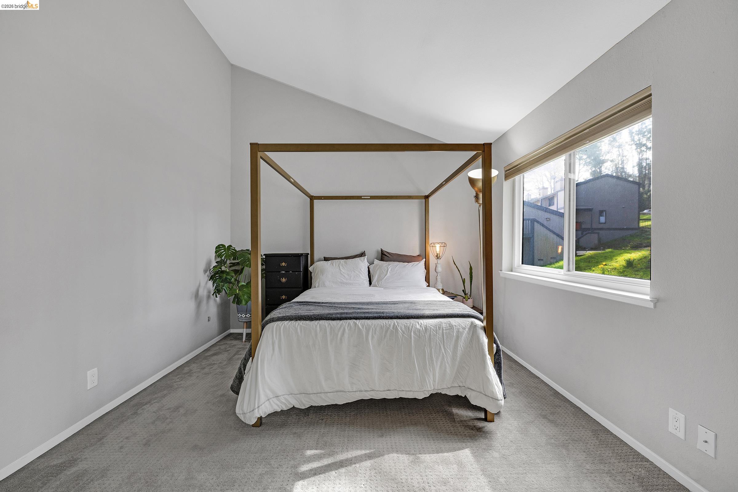 407 Vista Heights Road El Cerrito, CA 94530 - Photo 16 of 29 Carpeted bedroom with vaulted ceiling and baseboards