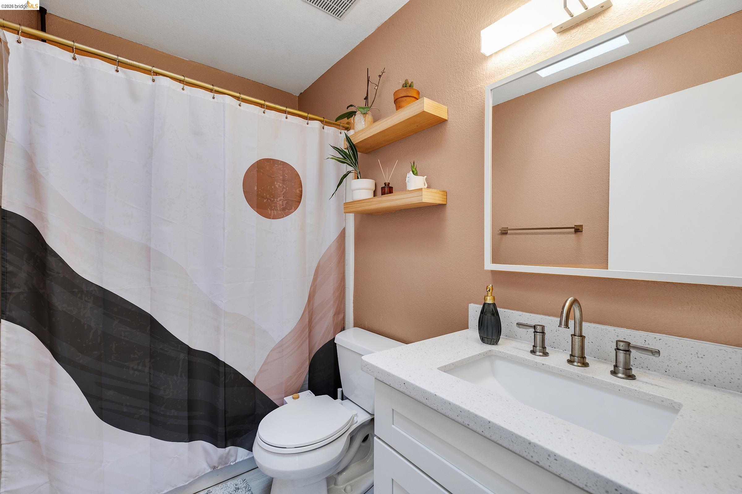 407 Vista Heights Road El Cerrito, CA 94530 - Photo 18 of 29 Bathroom with vanity and a shower with curtain