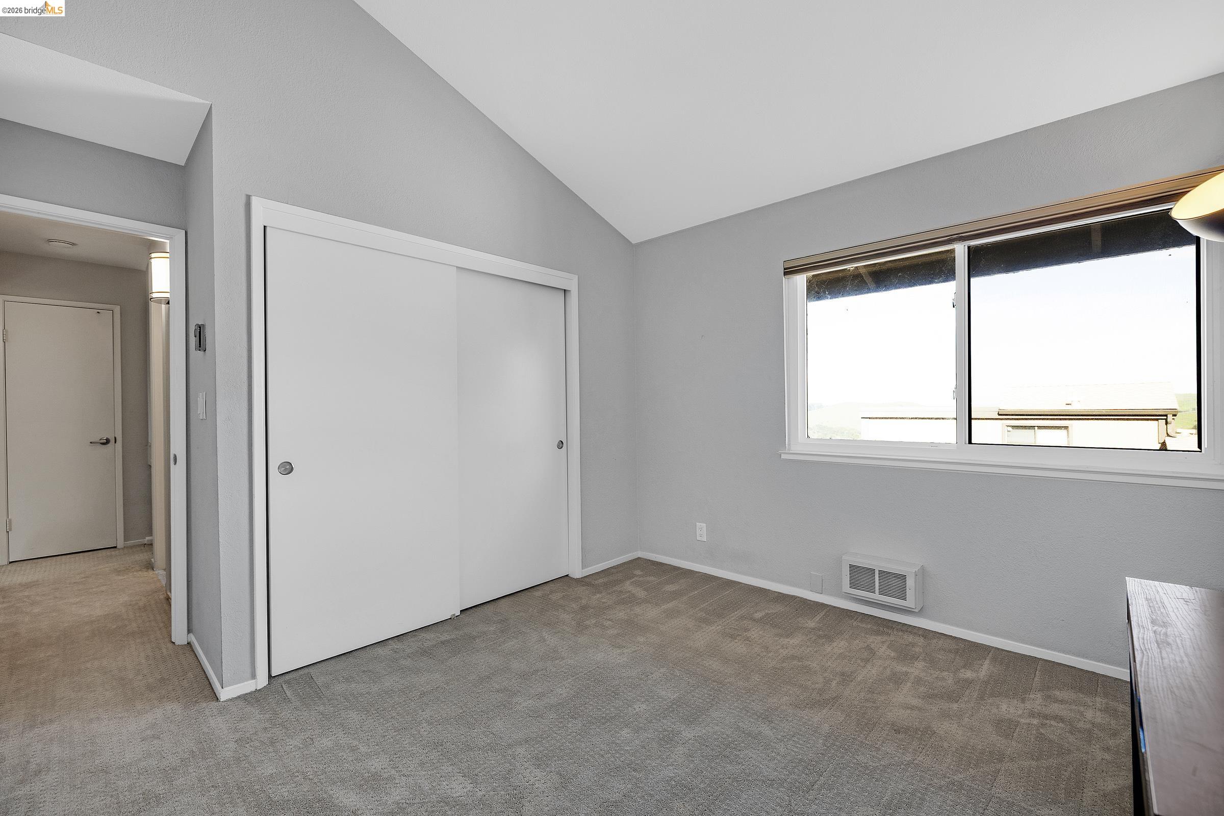 407 Vista Heights Road El Cerrito, CA 94530 - Photo 20 of 29 Unfurnished bedroom with carpet, a closet, and vaulted ceiling