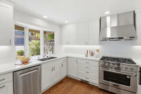a kitchen with a sink stove and cabinets