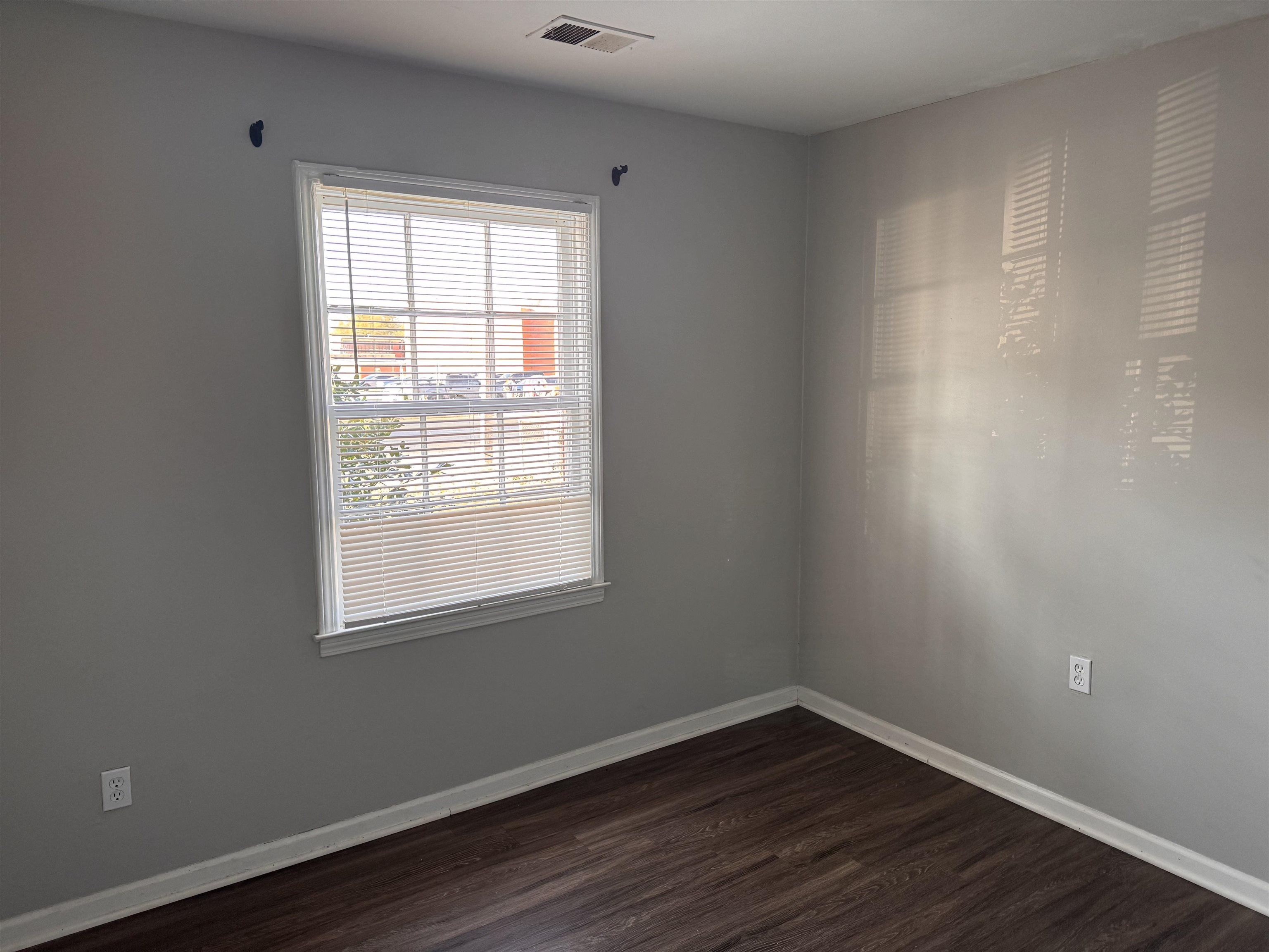 3788 Bishops Bridge Road Memphis, TN 38118 - Photo 13 of 22 an empty room with wooden floor and windows