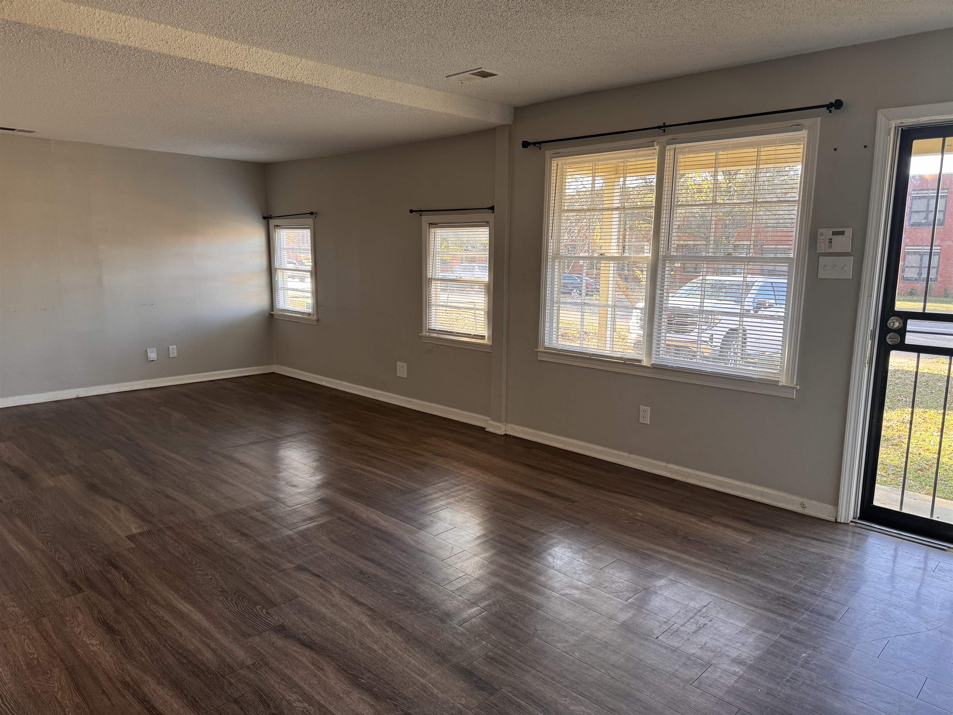 3788 Bishops Bridge Road Memphis, TN 38118 - Photo 4 of 22 a view of an empty room with wooden floor and a window
