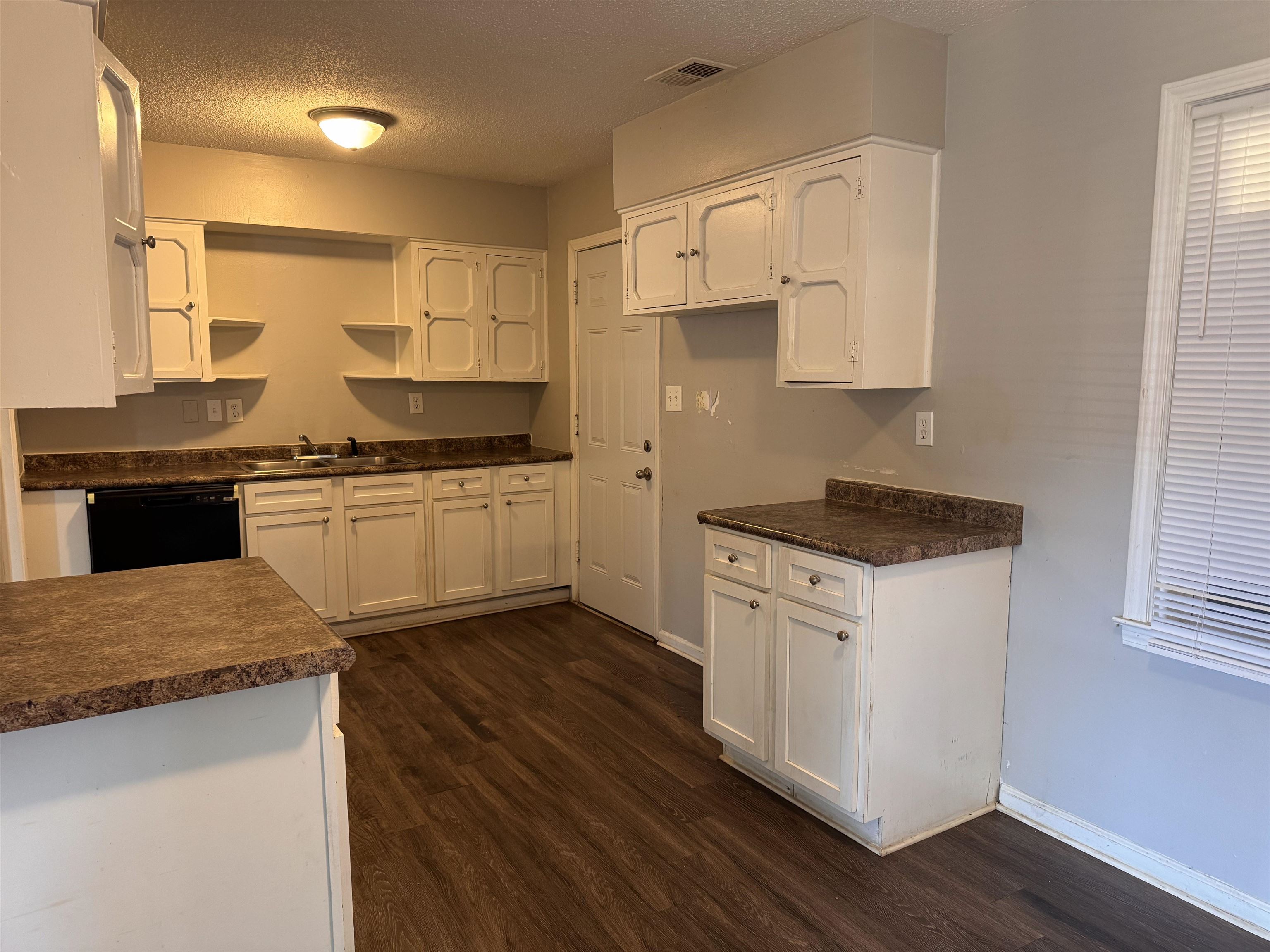 3788 Bishops Bridge Road Memphis, TN 38118 - Photo 6 of 22 a kitchen with stainless steel appliances granite countertop a stove a sink and white cabinets