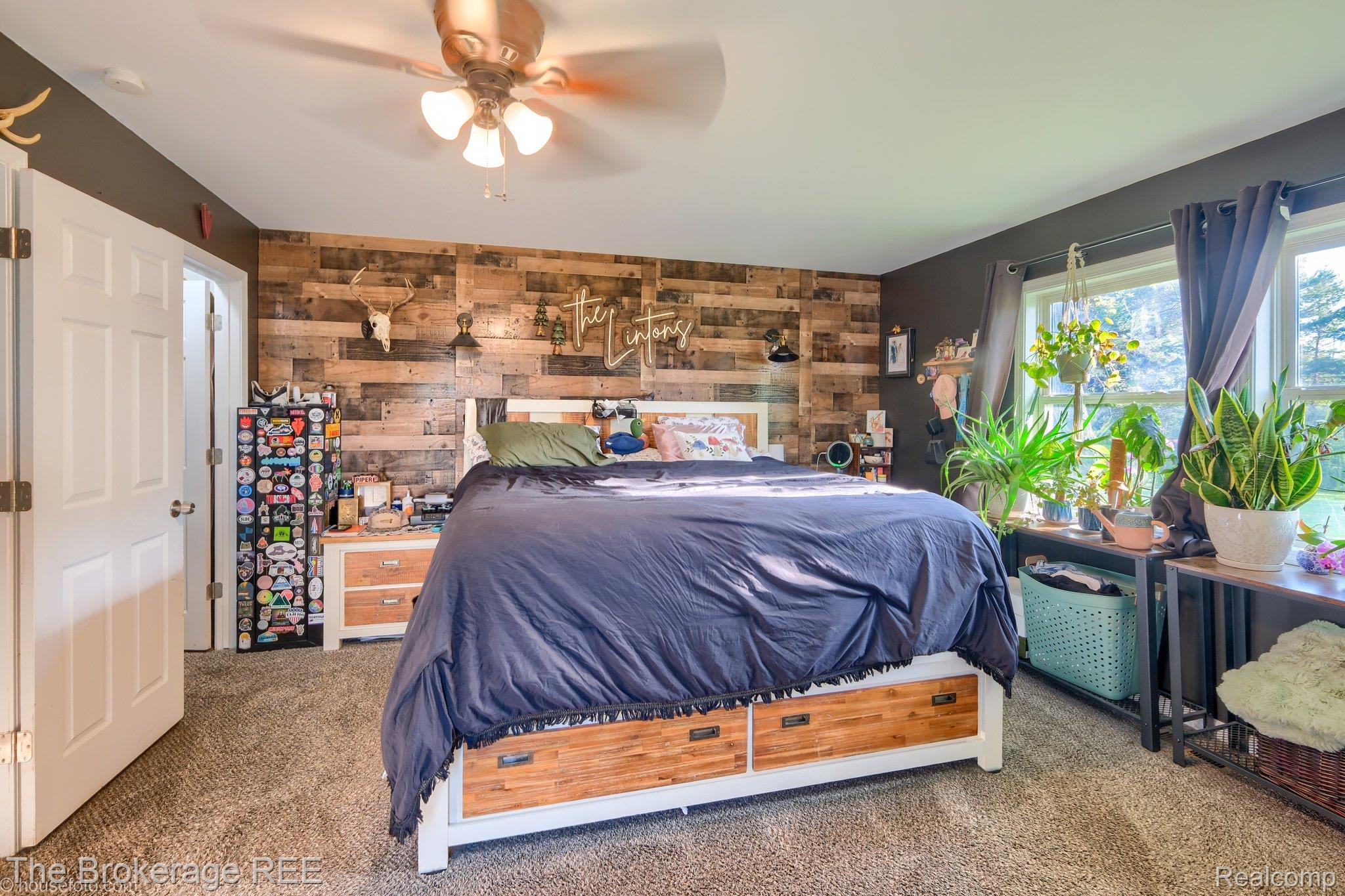 6288 Porter Road Grand Blanc, MI 48439 - Photo 24 of 39 Carpeted bedroom featuring wooden walls, a ceiling fan, and an accent wall