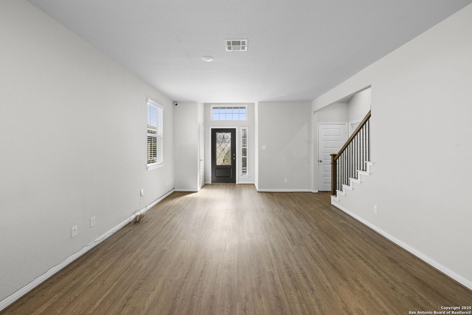 5139 Longhorn Converse, TX 78109 - Photo 12 of 46 a view of an empty room with wooden floor and a window