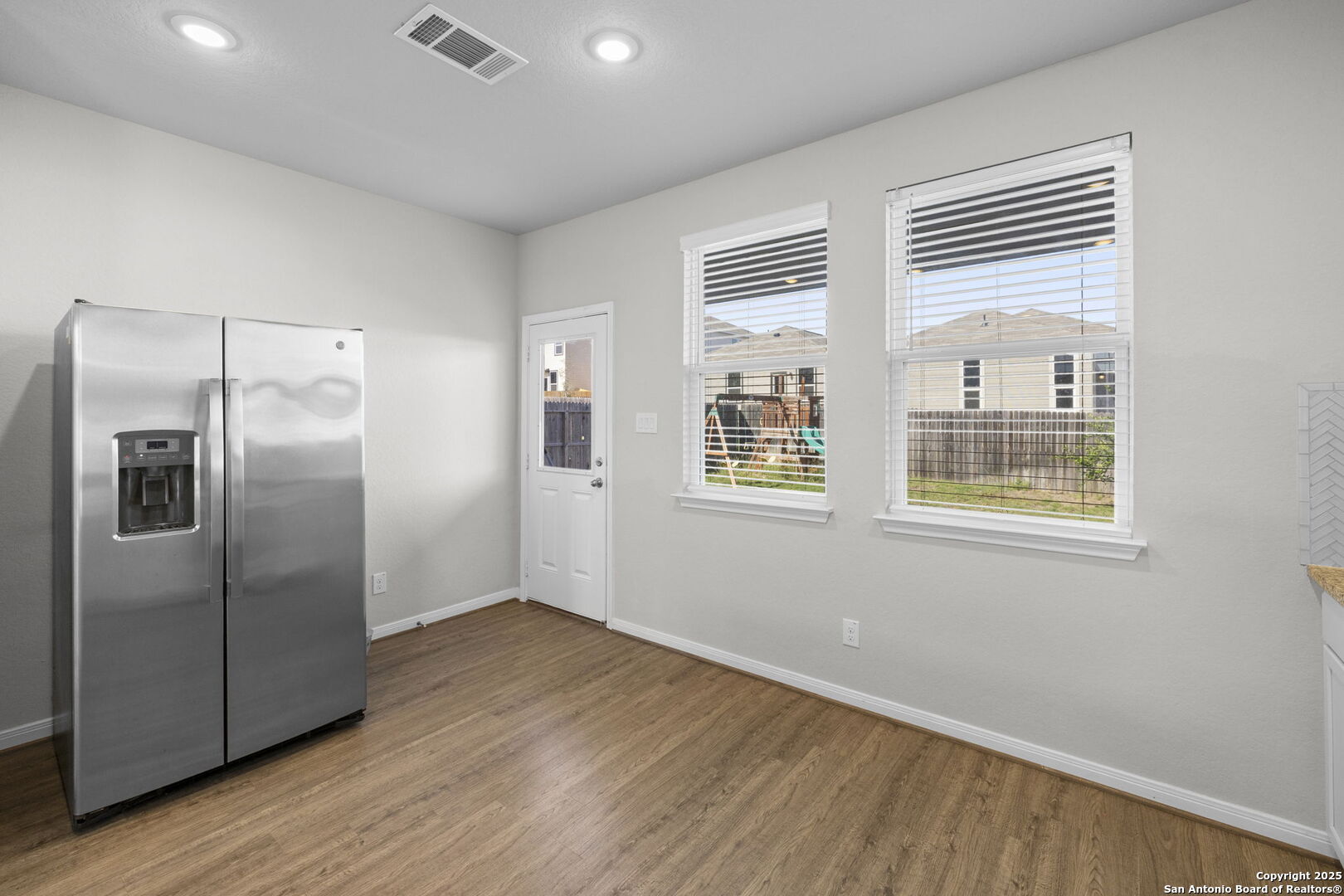 5139 Longhorn Converse, TX 78109 - Photo 14 of 46 a view of an empty room with wooden floor and a window