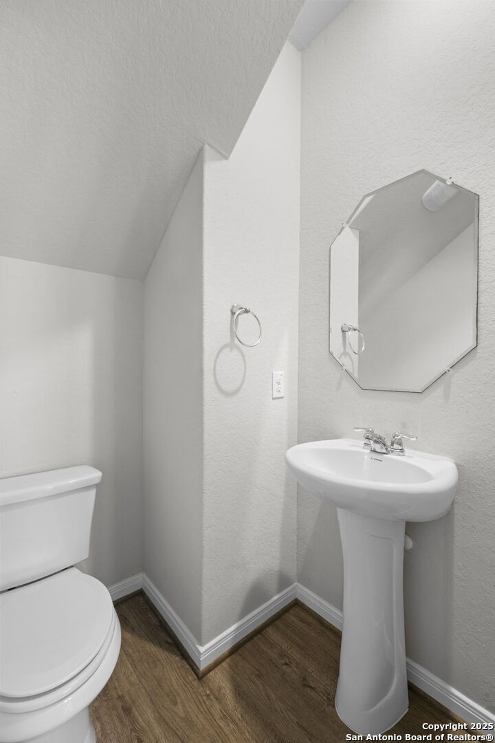 5139 Longhorn Converse, TX 78109 - Photo 17 of 46 a bathroom with a toilet a sink and mirror