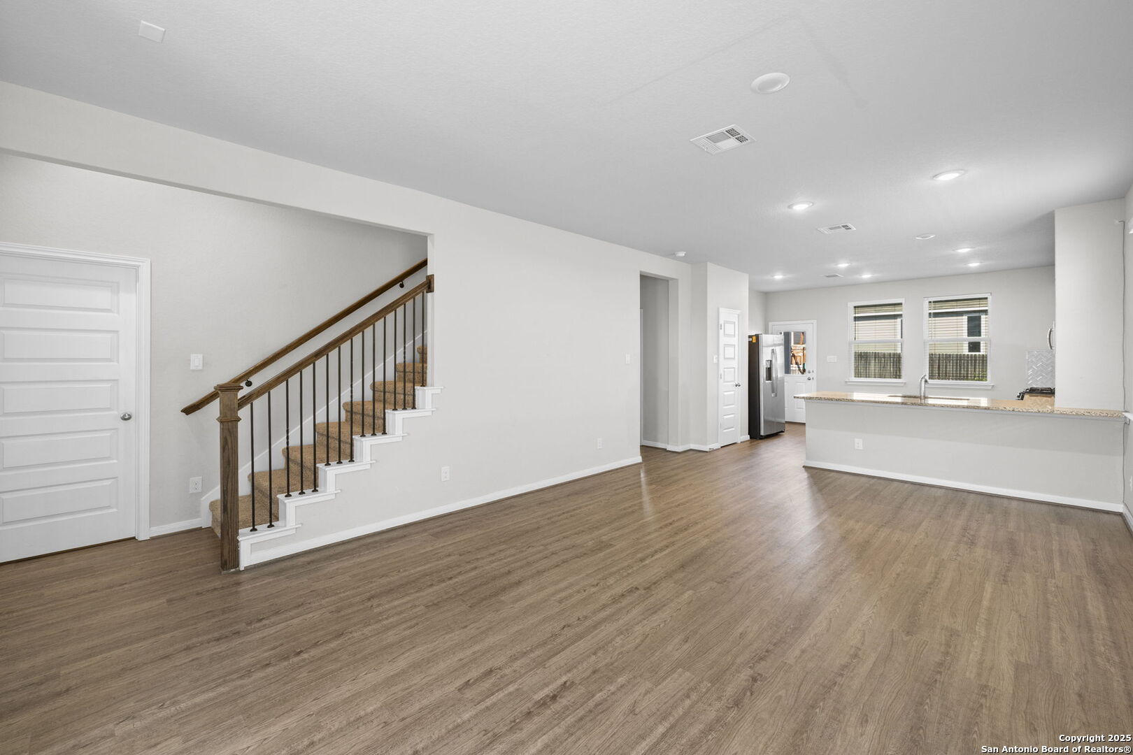 5139 Longhorn Converse, TX 78109 - Photo 10 of 46 a view of an empty room with wooden floor and windows