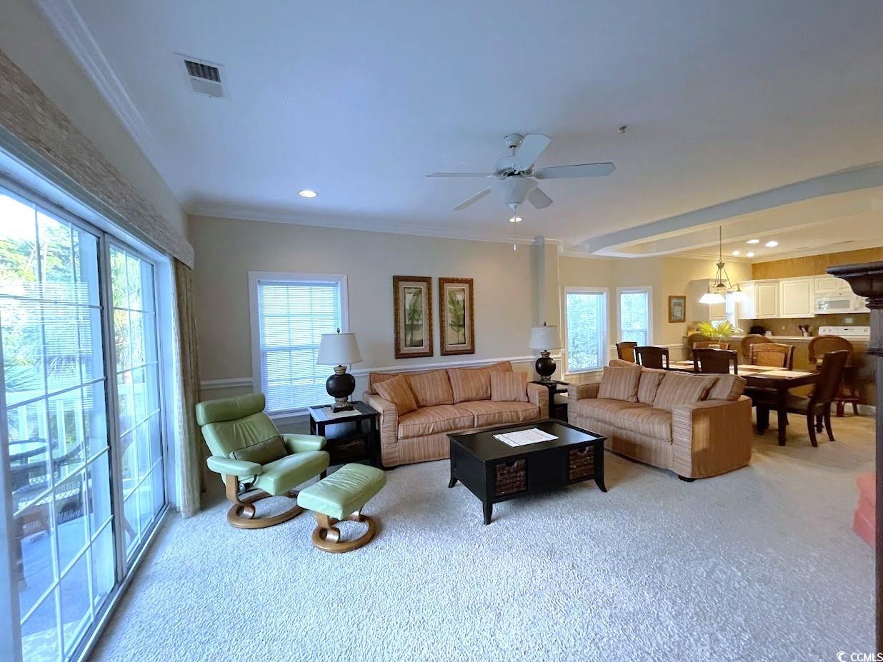 1008 Ray Costin Way, Unit 310 Murrells Inlet, SC 29576 - Photo 28 of 40 Living room with crown molding, light carpet, ceiling fan, and a wealth of natural light
