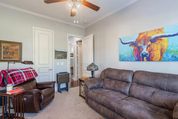 a living room with furniture a couch and a painting on the wall