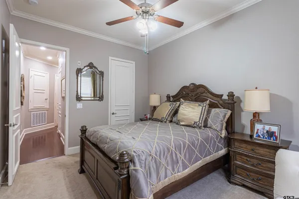 a bedroom with a bed and a chandelier