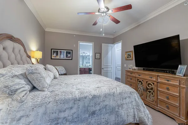 a bedroom with a large bed and a flat screen tv