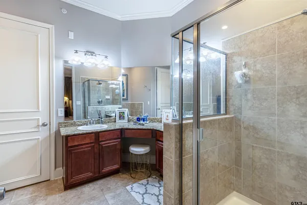 a bathroom with a double vanity sink mirror and shower