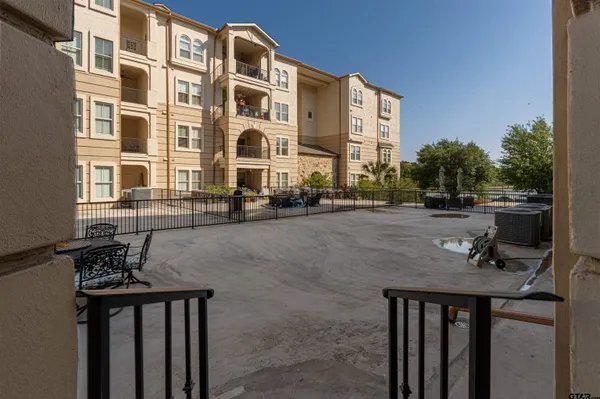 a view of a patio with couches and table and chairs and potted plants