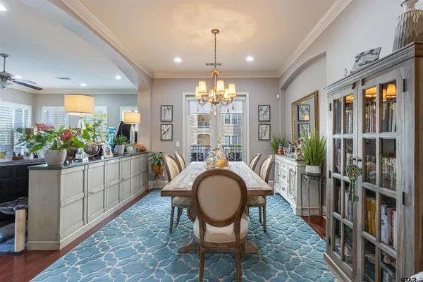 a dining room with furniture window and wooden floor