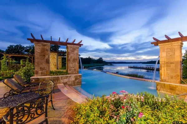 a view of a green yard with large trees
