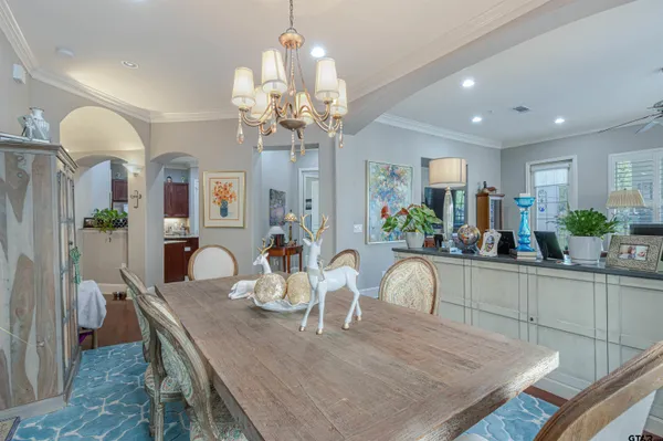 a view of a dining room with furniture and chandelier