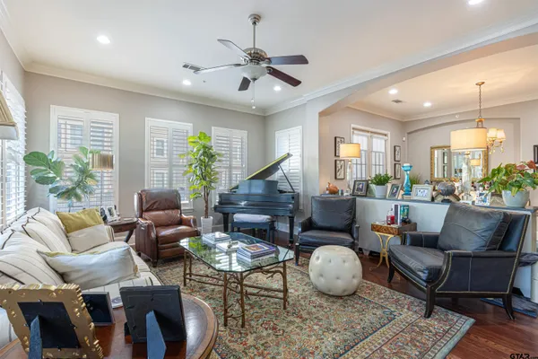 a living room with furniture potted plant and a large window