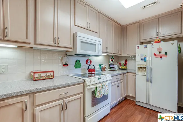a kitchen with stainless steel appliances granite countertop a refrigerator sink and cabinets