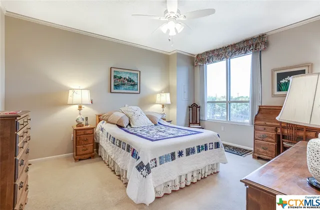 a bedroom with a bed and a table lamp