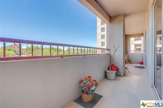 a view of a street with a couple of cars parked in front of it