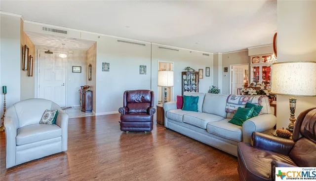 a living room with furniture and a wooden floor