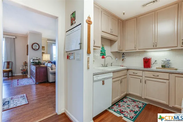 a kitchen with stainless steel appliances granite countertop a refrigerator sink and cabinets