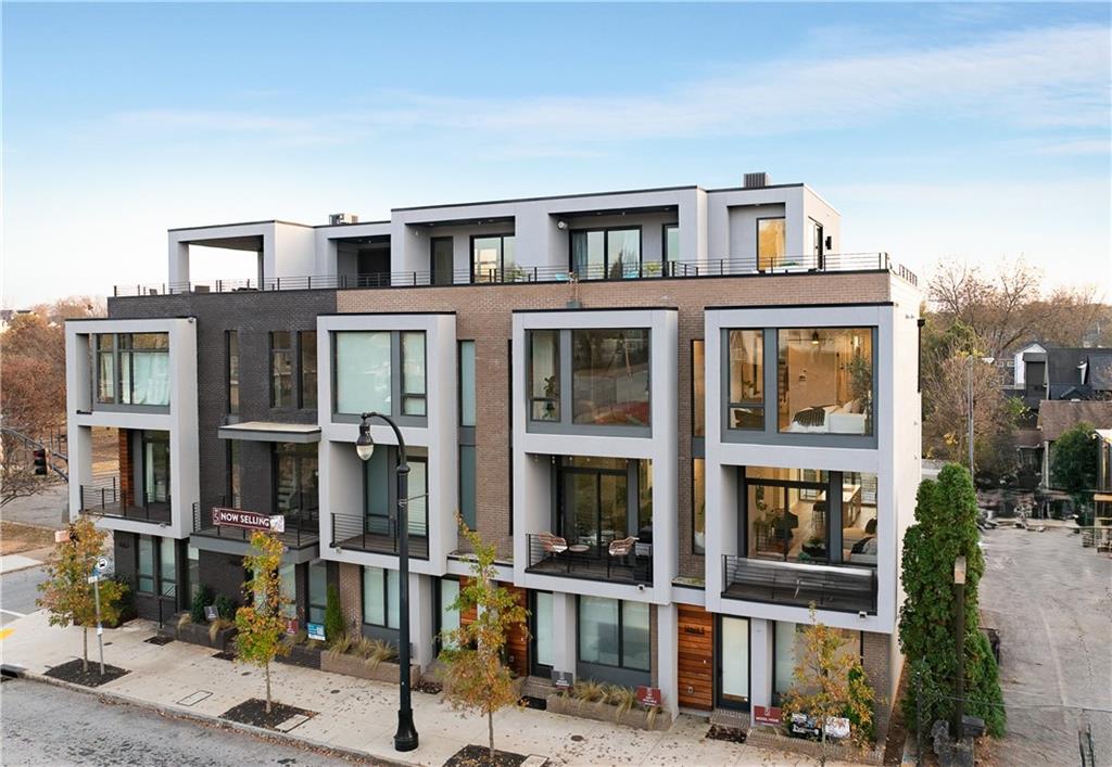 105 Georgia Avenue Southeast, Unit 1 Atlanta, GA 30312 - Photo 1 of 40 a front view of a residential apartment building with a yard