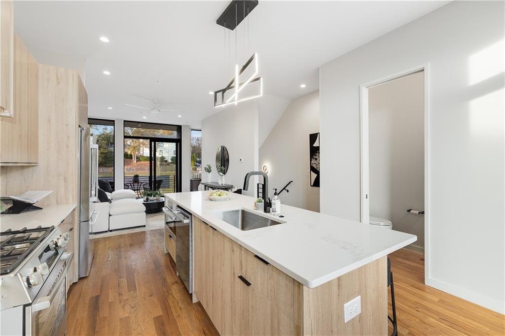 105 Georgia Avenue Southeast, Unit 1 Atlanta, GA 30312 - Photo 11 of 40 a kitchen with a sink a counter top space and stainless steel appliances