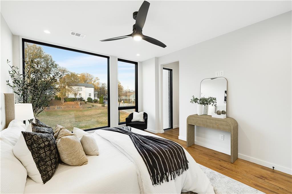 105 Georgia Avenue Southeast, Unit 1 Atlanta, GA 30312 - Photo 15 of 40 a bedroom with a large bed and a large window