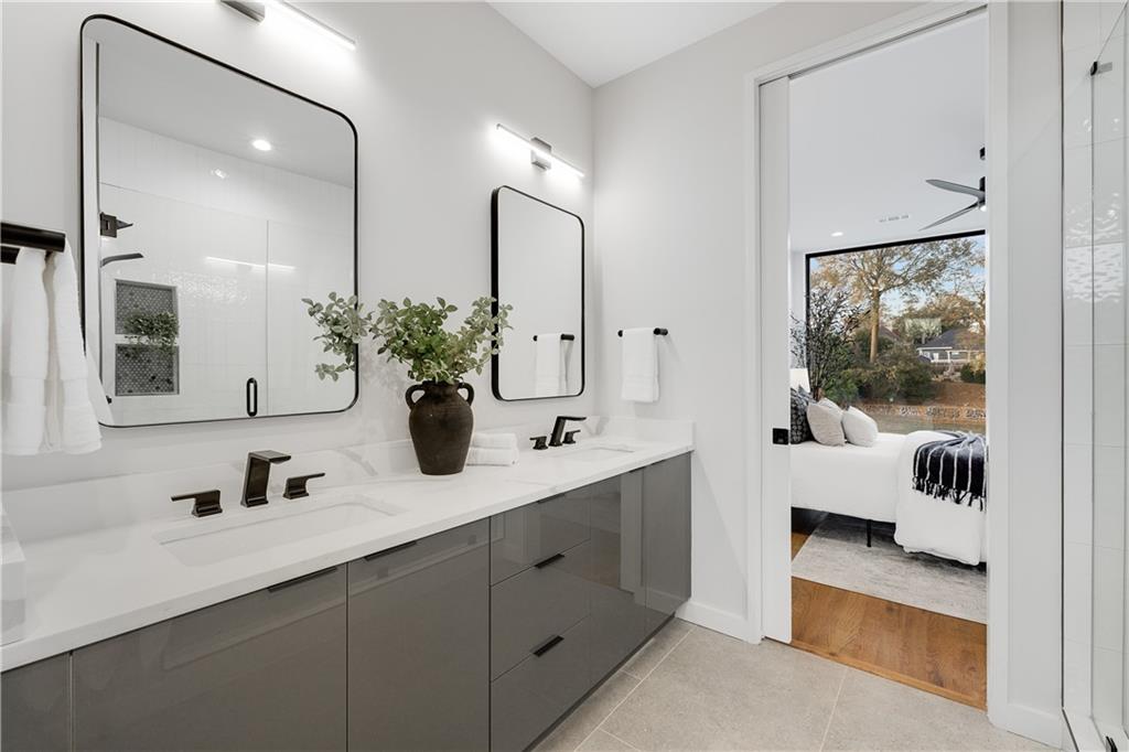 105 Georgia Avenue Southeast, Unit 1 Atlanta, GA 30312 - Photo 16 of 40 a en suite bathroom with double sink and a mirror