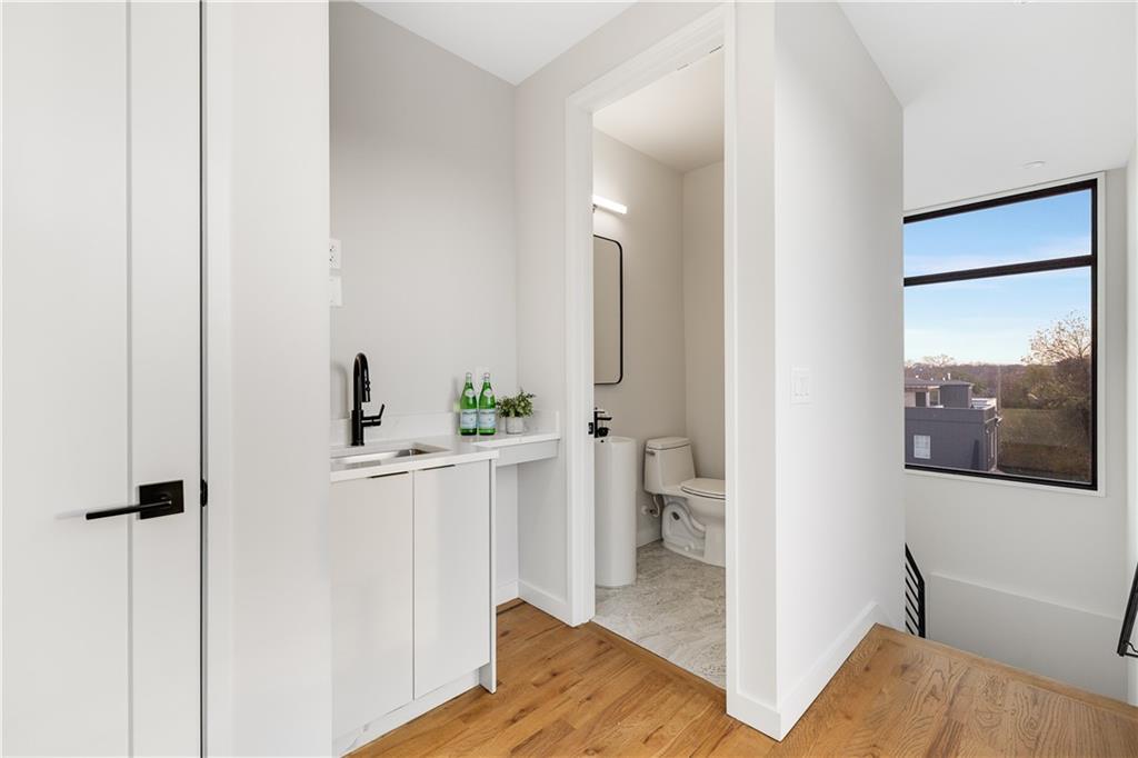 105 Georgia Avenue Southeast, Unit 1 Atlanta, GA 30312 - Photo 23 of 40 a bathroom with a sink and mirror with toilet