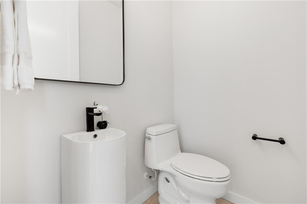 105 Georgia Avenue Southeast, Unit 1 Atlanta, GA 30312 - Photo 25 of 40 a white toilet sitting next to a bathroom sink