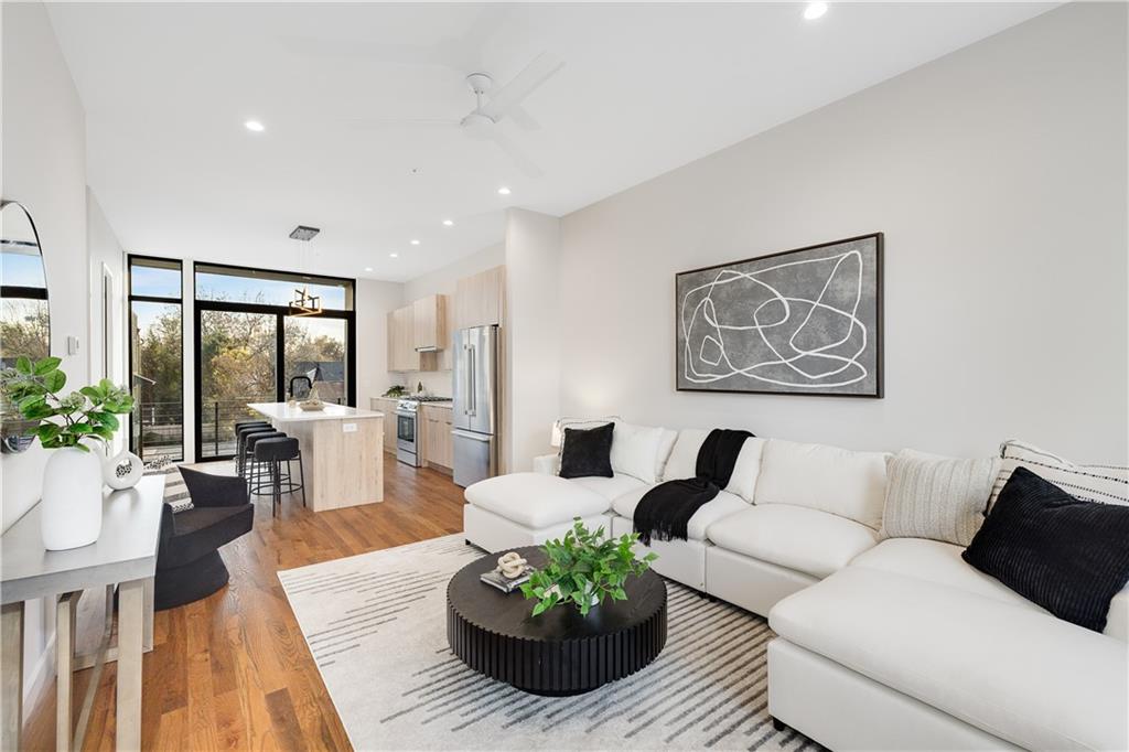 105 Georgia Avenue Southeast, Unit 1 Atlanta, GA 30312 - Photo 6 of 40 a living room with furniture potted plant and large windows